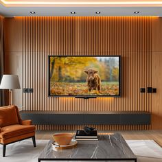 a living room with a large flat screen tv mounted on the wall next to a brown chair