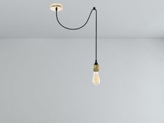 a light bulb hanging from the ceiling in an empty room with no one around it