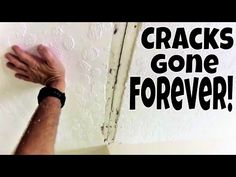 a hand that is on the side of a wall with cracks gone forever written on it