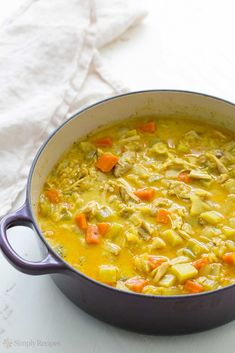 a large pot filled with soup on top of a white countertop next to a napkin