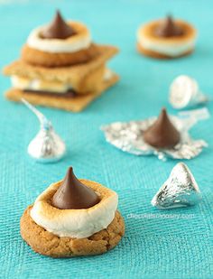 some cookies with marshmallows and chocolate on top are sitting on a table