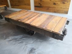 a wooden table sitting on top of a metal cart