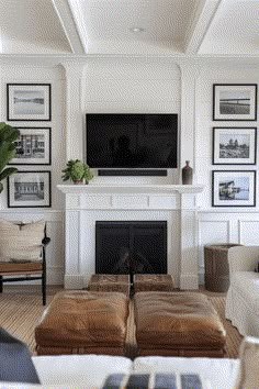 a living room with white walls and pictures on the wall