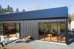 a black metal building with sliding glass doors