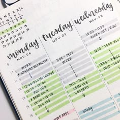 an open planner with the words monday, tuesday and friday written on it in black ink