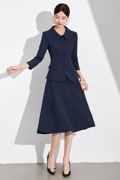 Navy Blue A-Line Skirt Suit with Peter Pan Collar for Classic Elegance Exude Classic Elegance with the Navy Blue A-Line Skirt Suit Discover timeless sophistication with our Navy Blue A-Line Skirt Suit, a wardrobe essential for the modern woman who values both style and grace. This two-piece ensemble features a beautifully tailored jacket with a chic Peter Pan collar and matching A-line skirt that gently flares to create a flattering silhouette. The jacket's structured design, complete with fabri Coat And Skirt Formal, Coat And Skirt, Structured Jacket, Structured Design, Navy Skirt, Fabric Covered Button, The Navy, Style And Grace, Tailored Jacket