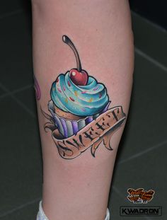 a cupcake tattoo with a cherry on it