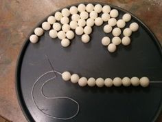 a black plate topped with marshmallows in the shape of a smiley face