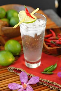 a glass filled with ice and garnished with a slice of lime