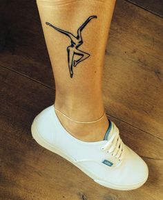 a woman's foot with a tattoo on it that has a bird in the middle