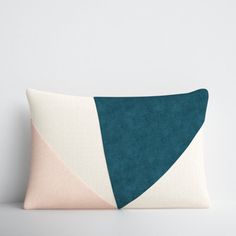 a blue and white pillow sitting on top of a table