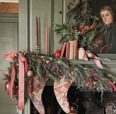 a fireplace mantle with stockings and candles on it