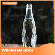 a glass bottle that is on top of a table with the words wholesale price written below it