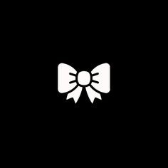 a black and white image of a bow tie on a dark background with the word,