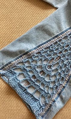 an old pair of jeans with crochet on them