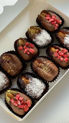 a box filled with chocolate covered desserts on top of a table