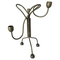 a metal candelabra with two candles on it's legs and arms