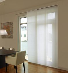 a dining room with sliding glass doors and chairs