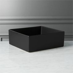 a black square box sitting on top of a white counter