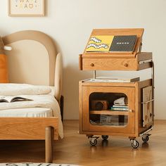 a bedroom with a bed, nightstand and small table on wheels in front of the bed