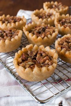 several small pies are cooling on a wire rack