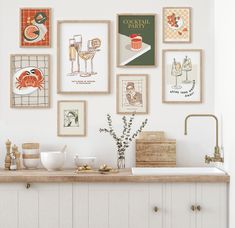 there are many pictures on the wall above the kitchen sink and counter top in this kitchen