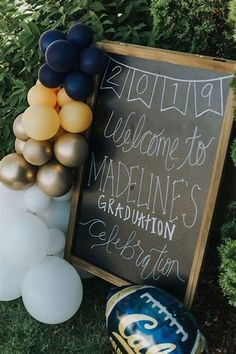 a welcome sign and balloons are on the grass near a chalkboard that reads, nothing is welcome to marine's graduation celebration