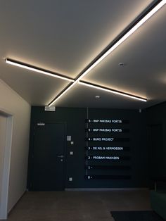 an empty room with some lights on the ceiling and other signs in front of it