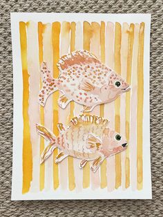 two small fish on a yellow and orange striped background