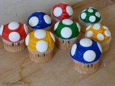 there are many cupcakes that have been decorated with different colors and designs on them