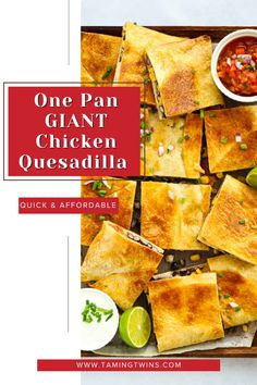 one pan glant chicken quesadilla on a tray with salsa and limes