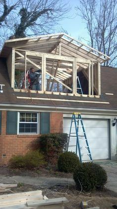 a man is working on the roof of a house