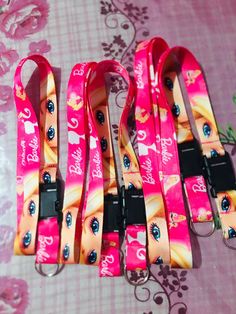 four pink lanyards with barbie dolls on them