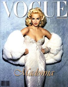 a woman in a white dress and fur coat on the cover of a magazine