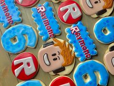 decorated cookies are arranged in the shape of letters, numbers and people's names