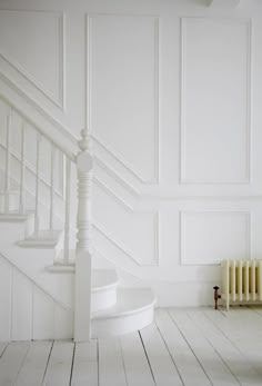 an image of a white room with stairs and paint swatches on the bottom right corner