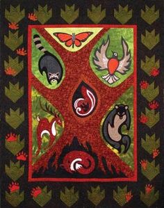 a quilt with animals on it and leaves around the edges in red, green, black and orange