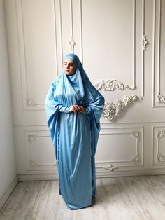 Tender light sky blue silk long khimar with high cuffs. This jilbab will be a good cover for you. Delicate fine silk ideal for summer weather. Always keep in mind that the fabric is enlightened, at the bottom have to be the dress. An elegant way for the believing women. Buttons secure the cuffs. Be sure when ordering in the note write the length of the khimar and the girth of the wrist.We can sew khimar in any other color! This handy headdress like those who do not yet know how to wind a scarf, Modest Blue Niqab For Eid, Blue Modest Khimar For Eid, Long Blue Khimar For Eid, Blue Long Khimar For Eid, Traditional Blue Hijab For Eid, Blue Long Sleeve Modest Khimar, Modest Long Sleeve Blue Kaftan, Elegant Blue Hijab For Eid, Blue Modest Long Abaya