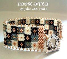 a close up of a bracelet on a white surface with the words hopscotch written below it