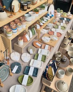 a table topped with lots of different types of plates and bowls next to each other