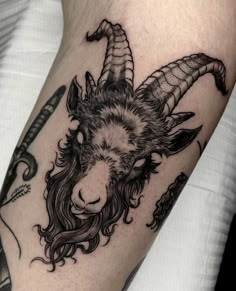 a goat with long hair and horns on its head is shown in this tattoo design