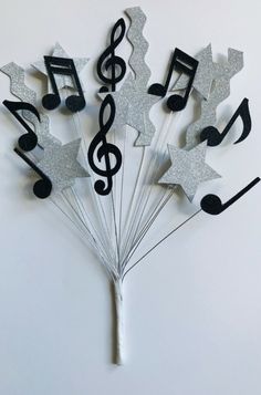 a bunch of musical notes and stars on sticks