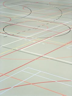 an indoor basketball court with lines painted on it