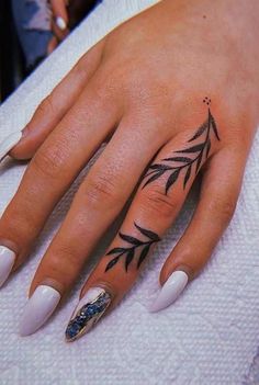 a woman's hand with a tattoo on it