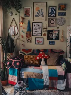 a living room filled with lots of furniture and pictures on the wall above it's couch