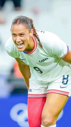 a female soccer player in action on the field