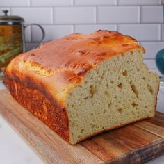 a loaf of bread sitting on top of a wooden cutting board next to a can