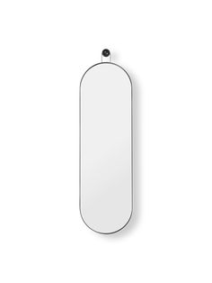 an oval mirror hanging on the wall next to a white wall mounted object with a black handle