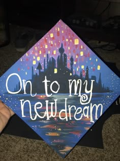 someone is holding up a graduation cap that says on to my new dream