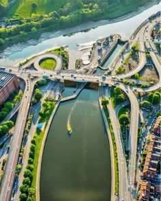 an aerial view of a bridge over a body of water with cars driving on it